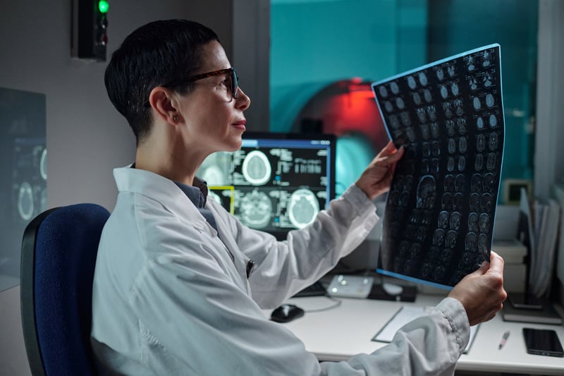 Medical professional reviewing scans